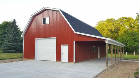 30'x48' gambrel pole barn with 12' walls and a 12'x48' open lean-to with attic.